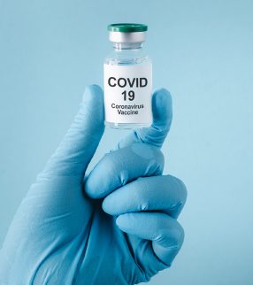 hand holding COVID-19 vaccine